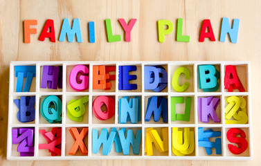 Family planning text with colorful text block on wood background