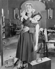 Frightened man supporting fainting woman 