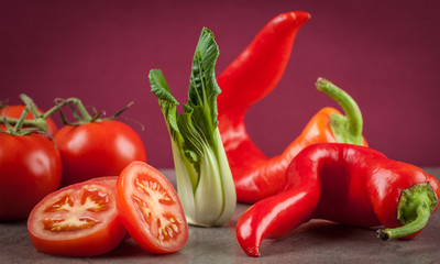 Tomatoes, sweet chilli, and bok choi. Healthy raw food composition. Shallow depth of field.