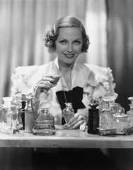 Portrait of woman with perfume bottles 