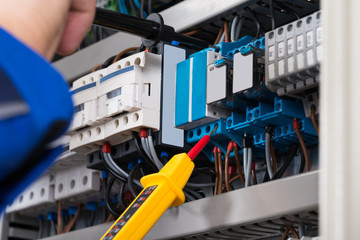 Male Electrician Checking Fusebox