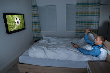 Man Watching Football Match On Television