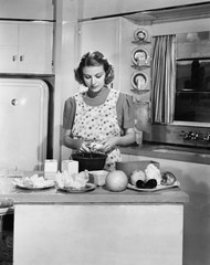 Young woman preparing food in the kitchen 