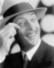Happy looking man with a monocle in his hand 