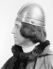 Portrait of a man in costume and a helmet looking away 