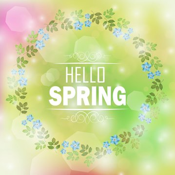 Circle floral frame with text hello spring and bokeh background