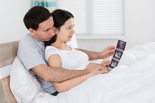 Couple Looking At Ultrasound Scan Of Their Expecting Baby