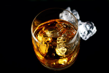 whiskey and ice on a black background