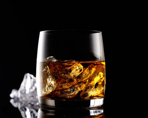 whiskey and ice on a black background