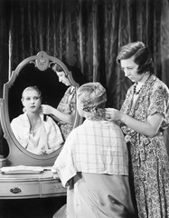 One woman doing an other woman's hair 