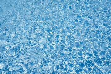 Swimming pool water with shiny sunlight reflection