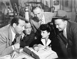 Group of people searching in a big book 