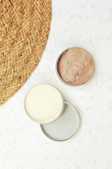 Top view of white and brown beauty creams