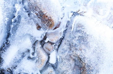 transparent ice with air bubbles and stones
