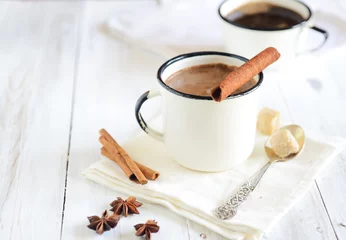 Photo sur Plexiglas Chocolat Hot cocoa with cinnamon sticks on white wooden background, star anise
