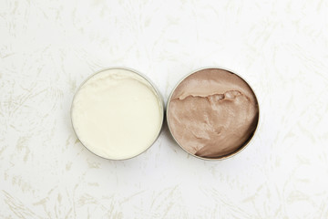 Top view of white and brown beauty creams