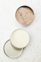 Top view of white and brown beauty creams