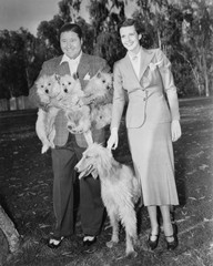 Couple outside with dog and puppies 