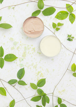 Top view of natural organic beauty cream with bath salt and leaves
