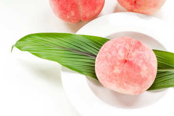 Ripe peaches in ceramic plate