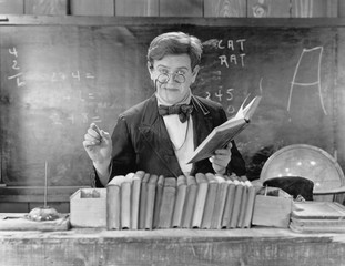 Man with glasses teaching in a classroom 