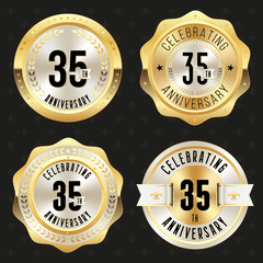 Collection of gold  35th anniversary badges on black background