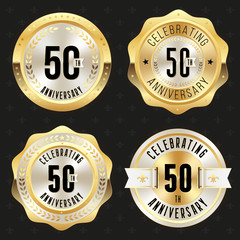 Collection of gold  50th anniversary badges on black background