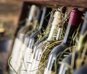 Fototapeta na wymiar Wine bottles on the wooden shelf.