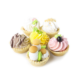 Cake basket in the sand with cream on a white background