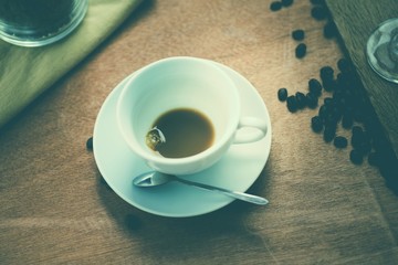 Completion of the coffee. Closeup empty cofee cup on wooden floo