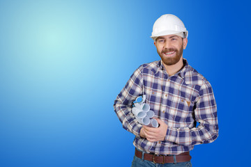 Young male engineer with helmet holding blueprints