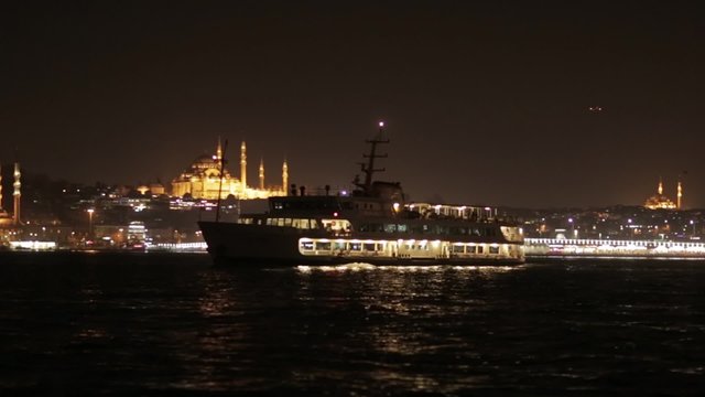 Night view of Istanbul from Bosphorus with boats and Mosques