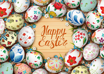 Easter eggs and flowers on the wooden table