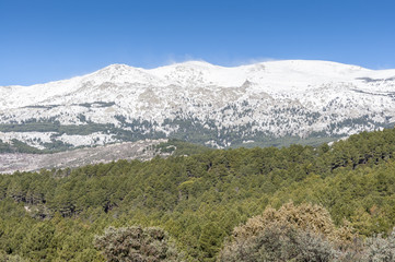 Views of La Pedriza from Canto Cochino, in Guadarrama Mountains National Park, Madrid, Spain. In the background can be seen Cabezas de Hierro peaks (Heads of Iron)