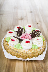 Cake with cream on a wooden table