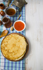 Pancakes with red caviar on a table