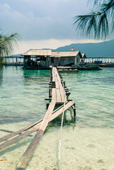 A partially broken pier leading to a fishing hut near Karimunjawa island, Indonesia.