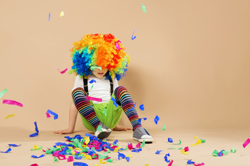 Obraz na płótnie Canvas Happy clown boy with large colorful wig