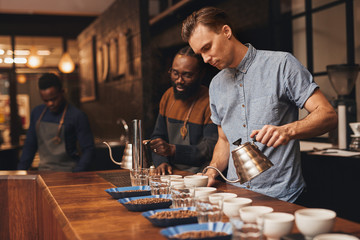 Baristas preparing a coffee tasting in modern roastery