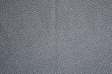 Grey fabric background with leather print close up