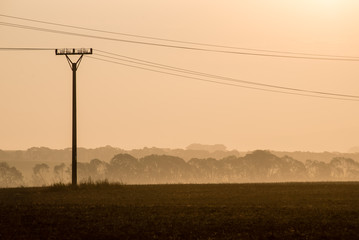sunset over the fields in fog