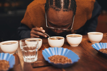 African man smelling the aroma of coffee at a tasting