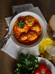 meatballs in tomato sauce, bread, tomatoes, herbs