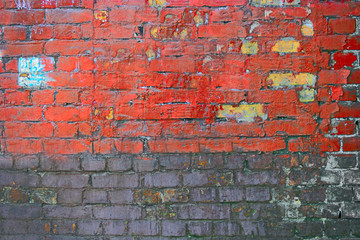 Weathered texture of stained old dark brown and red brick wall , grungy blocks half painted