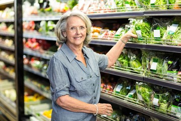 Senior woman picking out some vegetables