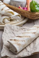burrito on parchment with vegetables