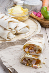 Breakfast burrito with eggs, cheddar, microgreens and roasted mu