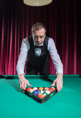 The player puts the balls to start the game in billiards