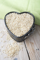 Ricel, heart-shaped box. Wooden surface.