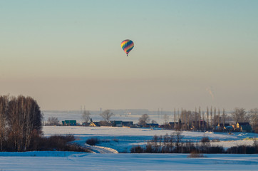 Balloon in the sky over winter village